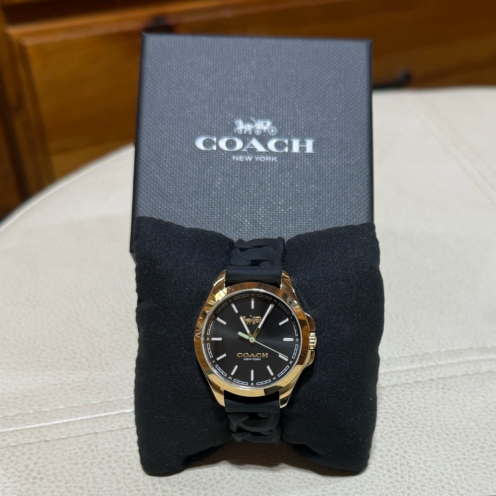 Coach women’s black and gold watch